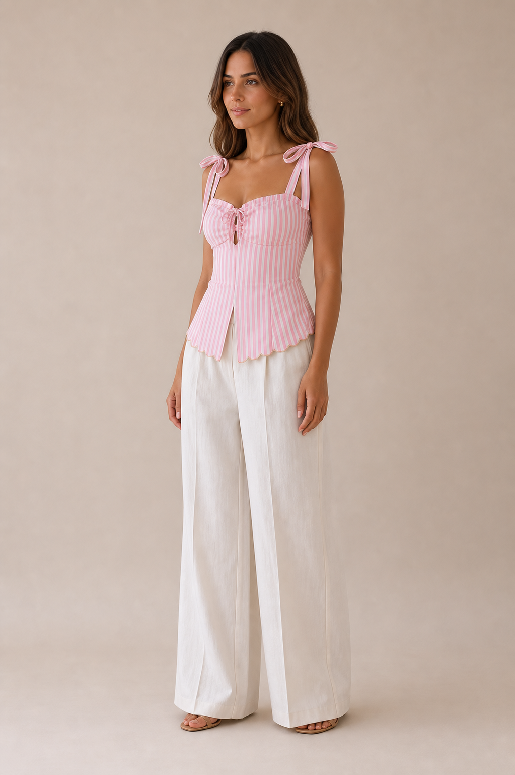 A playful pink candy stripe top featuring delicate tie up sleeves, a chic chest tie detail and elegantscalop edging at the hem.