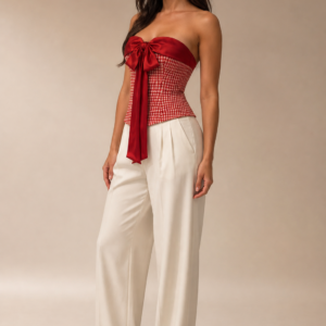 A red checkered top featuring a statement red satin bow detail.
