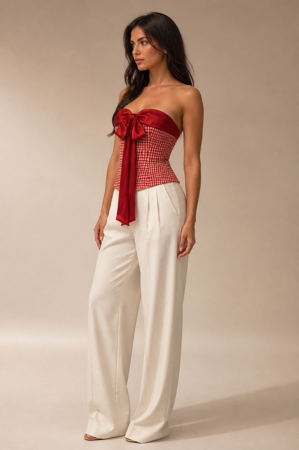 A red checkered top featuring a statement red satin bow detail.